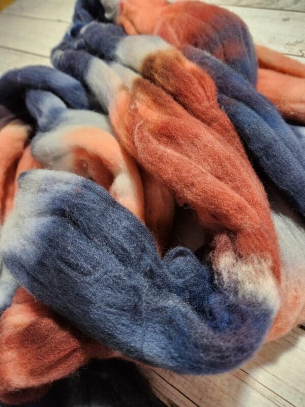 A skein of blue, red, and orange wool.