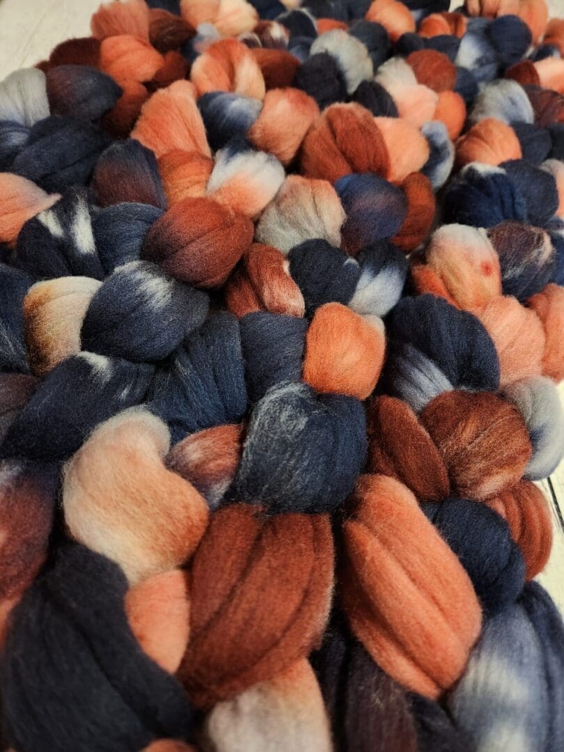 A pile of blue, orange, and brown wool.