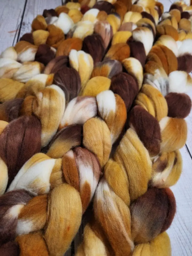 A pile of brown and white wool roving.