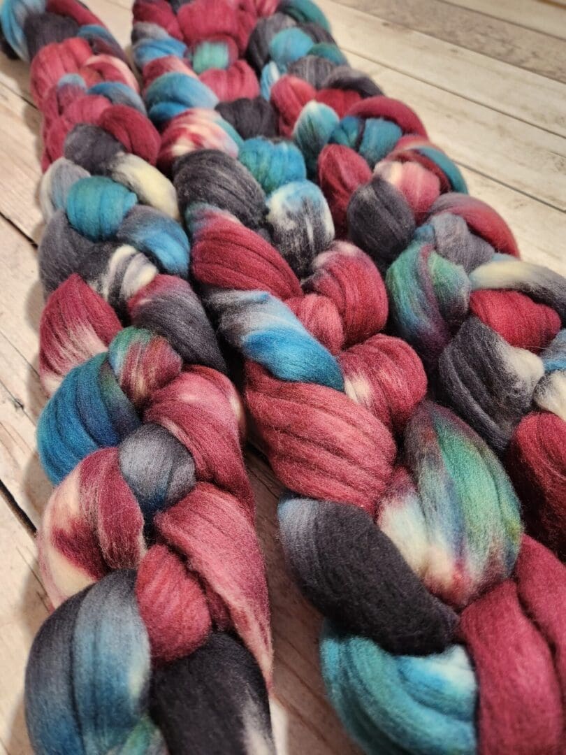 A skein of yarn with red, blue, and black colors.