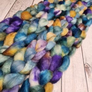 Disco Date, blue and yellow roving on a wooden table.