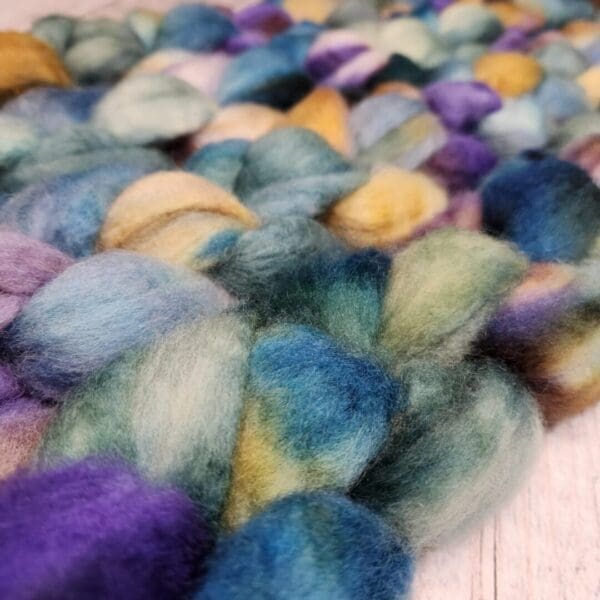 A close up of a bunch of colorful Disco Date ~ 100g Hand-Dyed Luxury Combed Top Fiber.