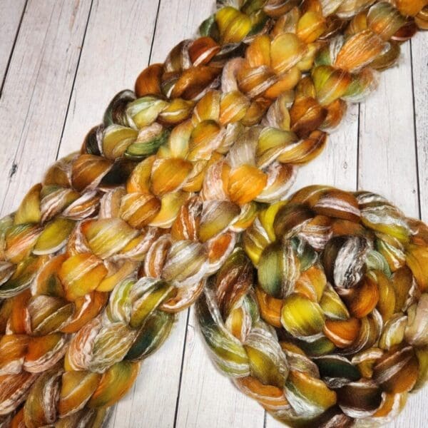 A yellow and brown yarn on a wooden table.