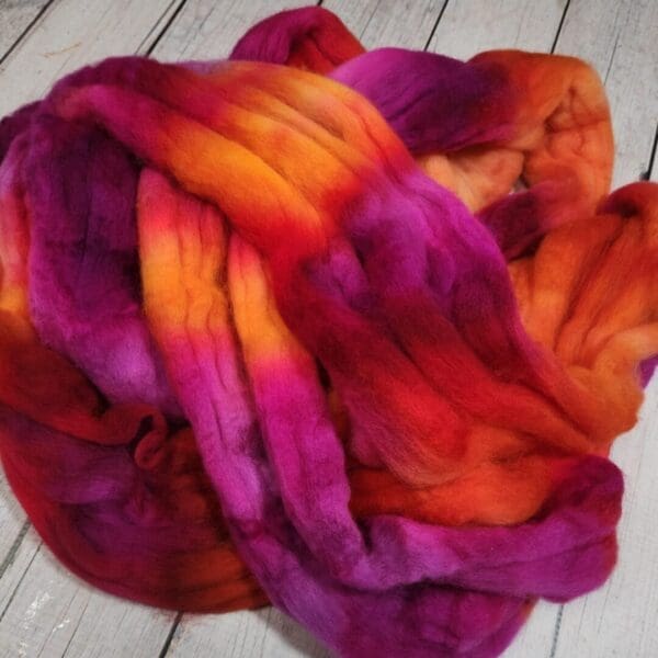 A skein of purple, orange, and yellow wool.