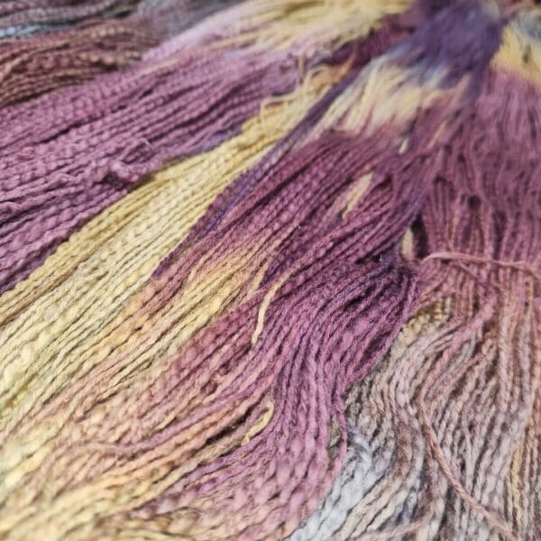 A close up of some purple and yellow dyed yarn.