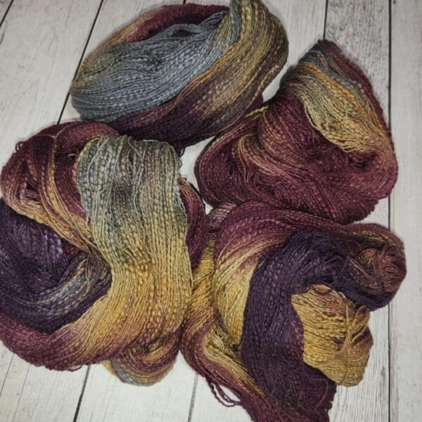 Three skeins of yarn in different colors.