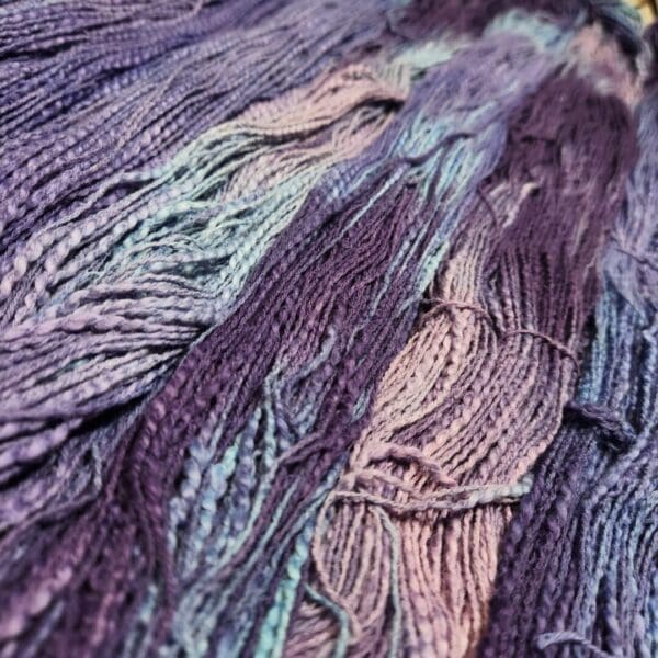 A close up of some purple and blue yarn.