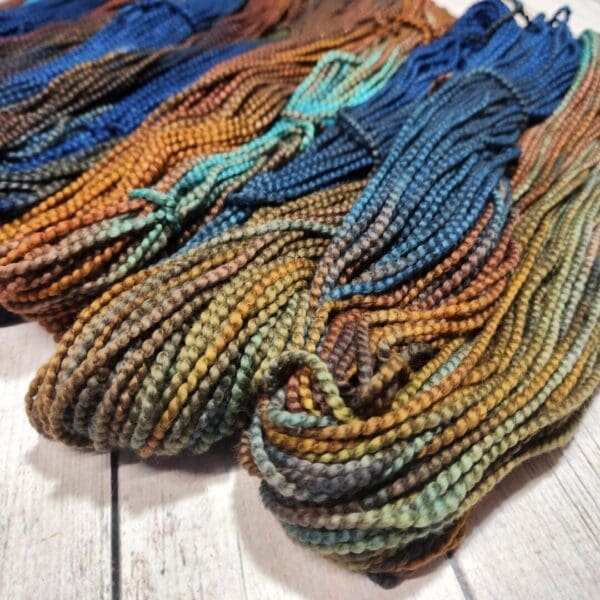 Four skeins of yarn in different colors.