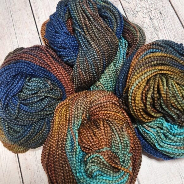 Four skeins of yarn in different colors.