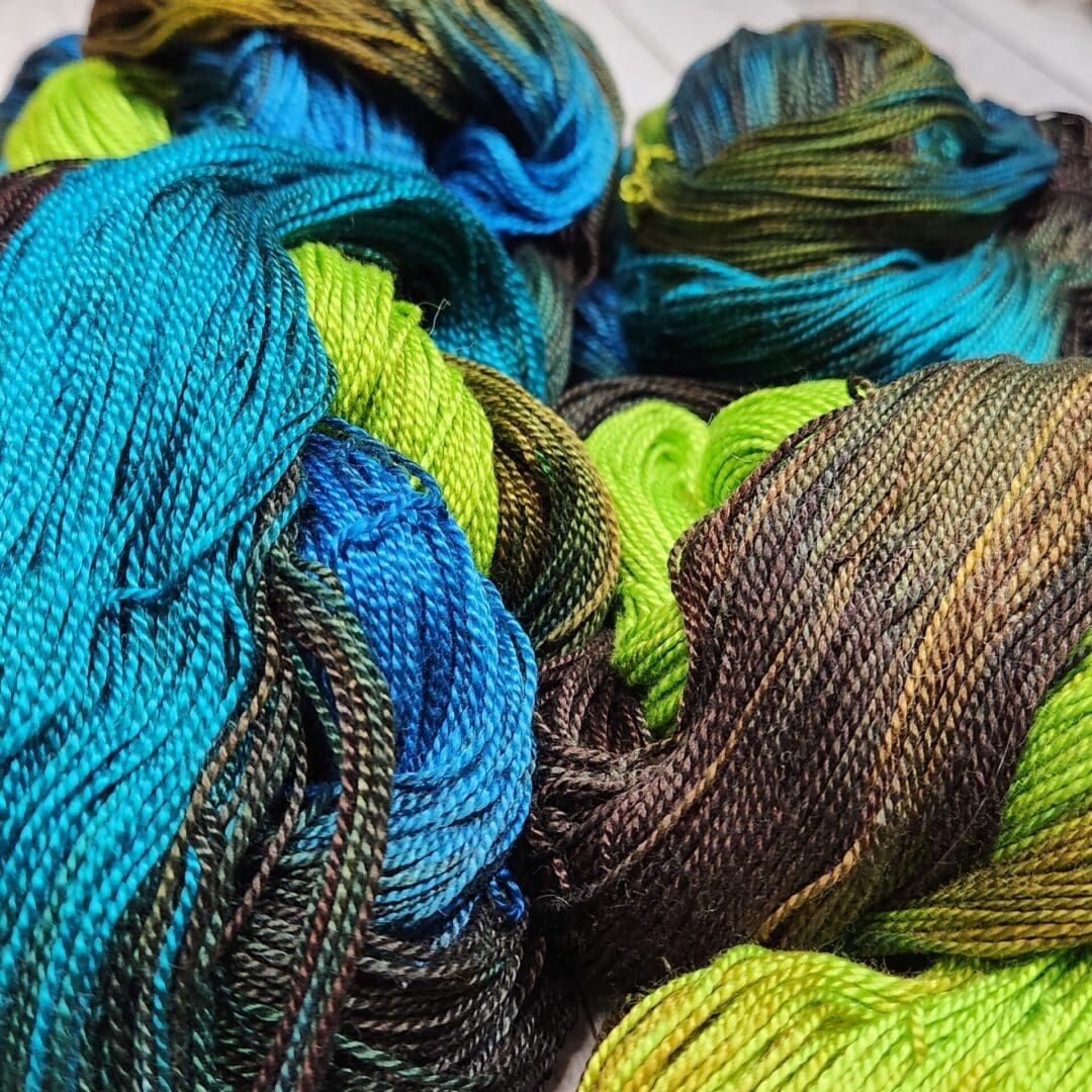 A skein of yarn with blue and green colors.