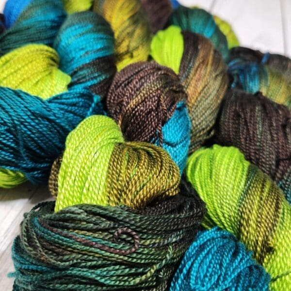 Skeins of yarn with blue and green colors.