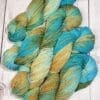 Four skeins of yarn in blue, green and yellow.