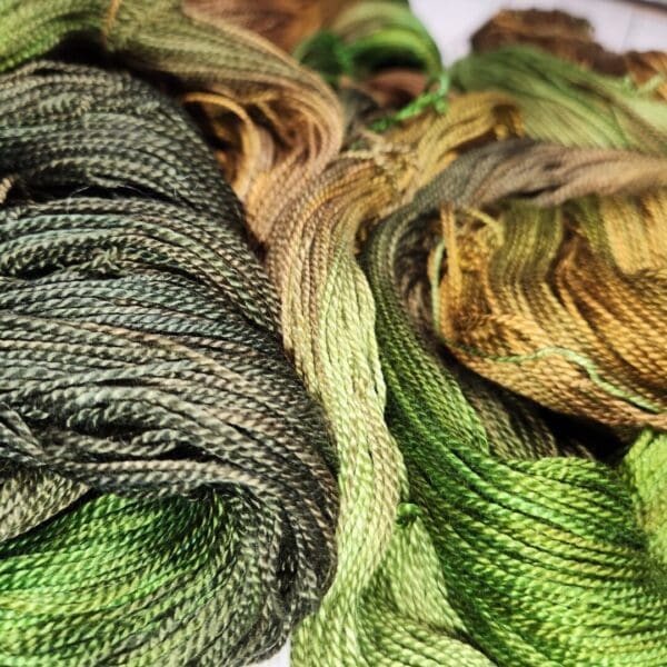Two skeins of green and brown yarn.