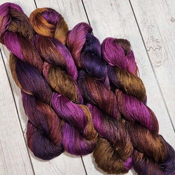 Purple and brown skeins on a wooden floor.
