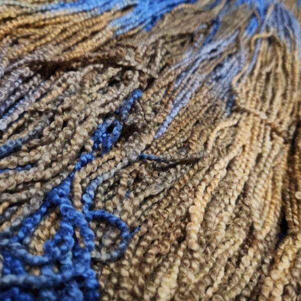 A close up of some blue and brown yarn.