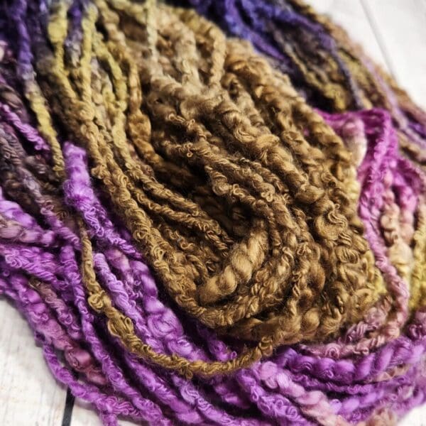 A close up of a purple and brown yarn.