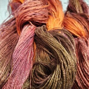 Two skeins of yarn with orange and brown colors.
