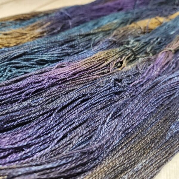 A close up of a skein of purple and blue yarn.