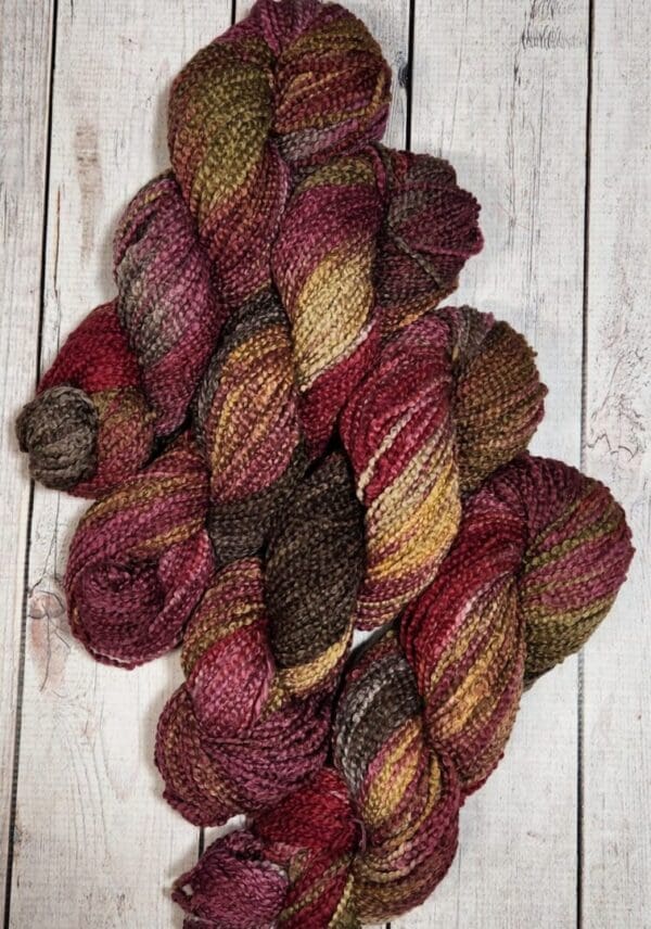A skein of yarn with red, brown and yellow colors.