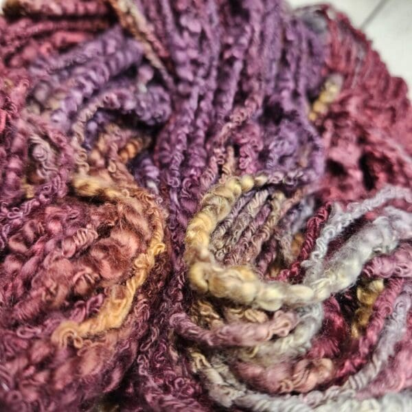 A close up of a skein of purple and yellow yarn.