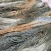 A close up of a bunch of green and brown dyed yarn.