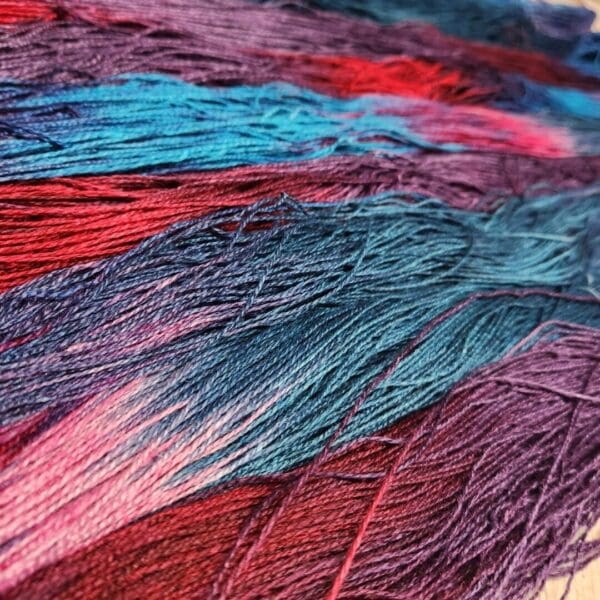 A close up of a bunch of colorful yarn.