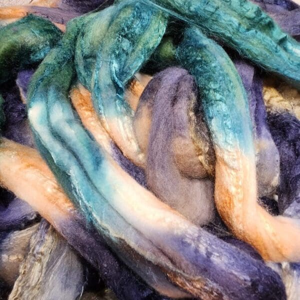 A pile of blue, green, and purple fibers.