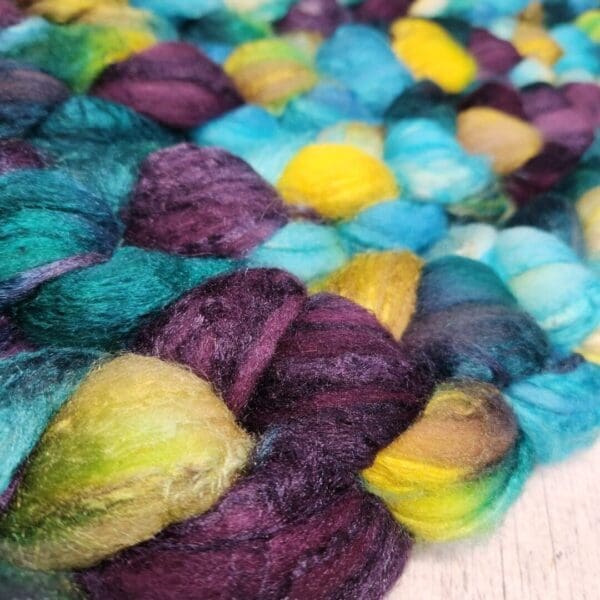 A close up of a purple, blue and yellow yarn.