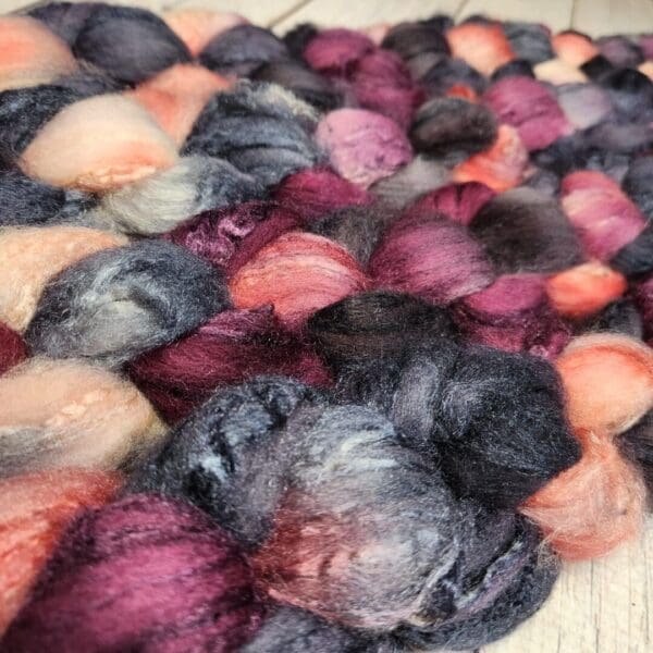 A close up of a bunch of different colored yarns.