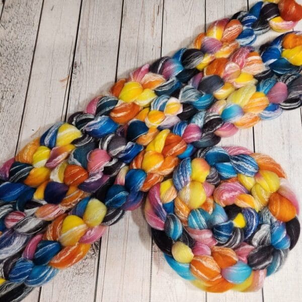 Multicolored roving on a wooden table.