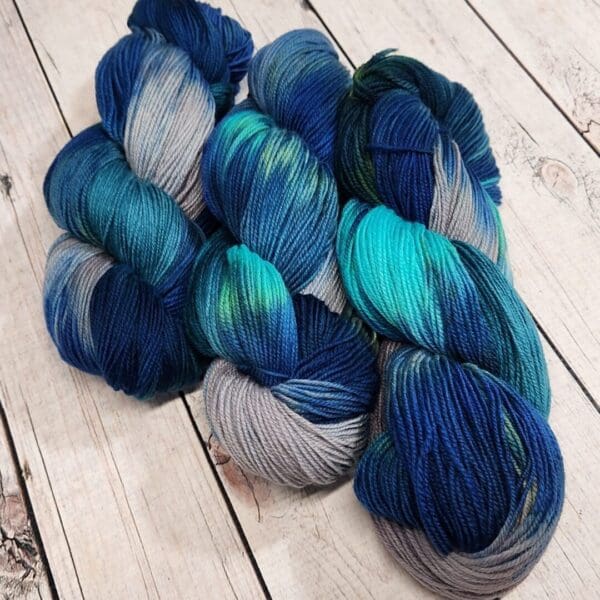 Blue and grey skeins on a wooden table.