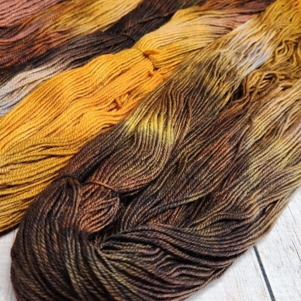 A skein of yarn with brown, yellow and orange colors.
