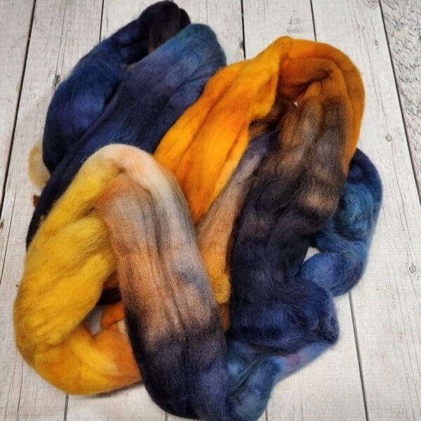 A skein of yarn with blue, yellow, and orange colors.