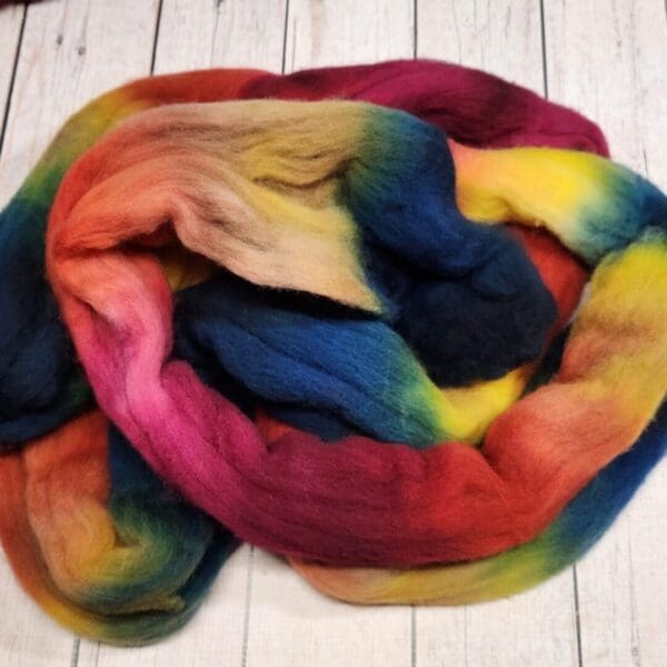 A skein of multicolored wool on a wooden table.