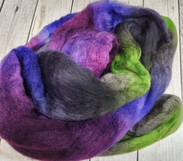 Purple, green, and blue wool roving.