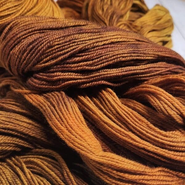 A skein of yarn with orange and brown colors.