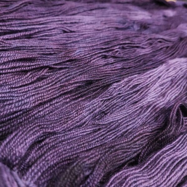 A close up of a purple skein of yarn.