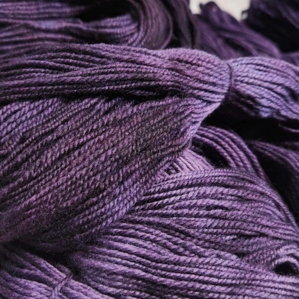 A close up of a purple skein of yarn.