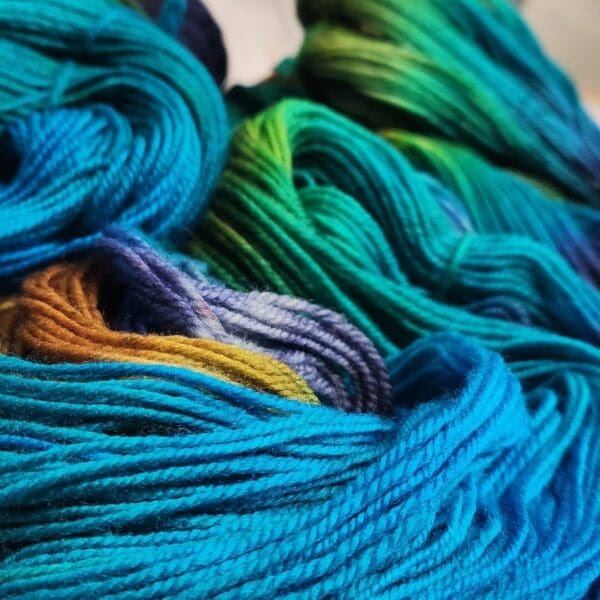 A close up of some blue and green yarn.