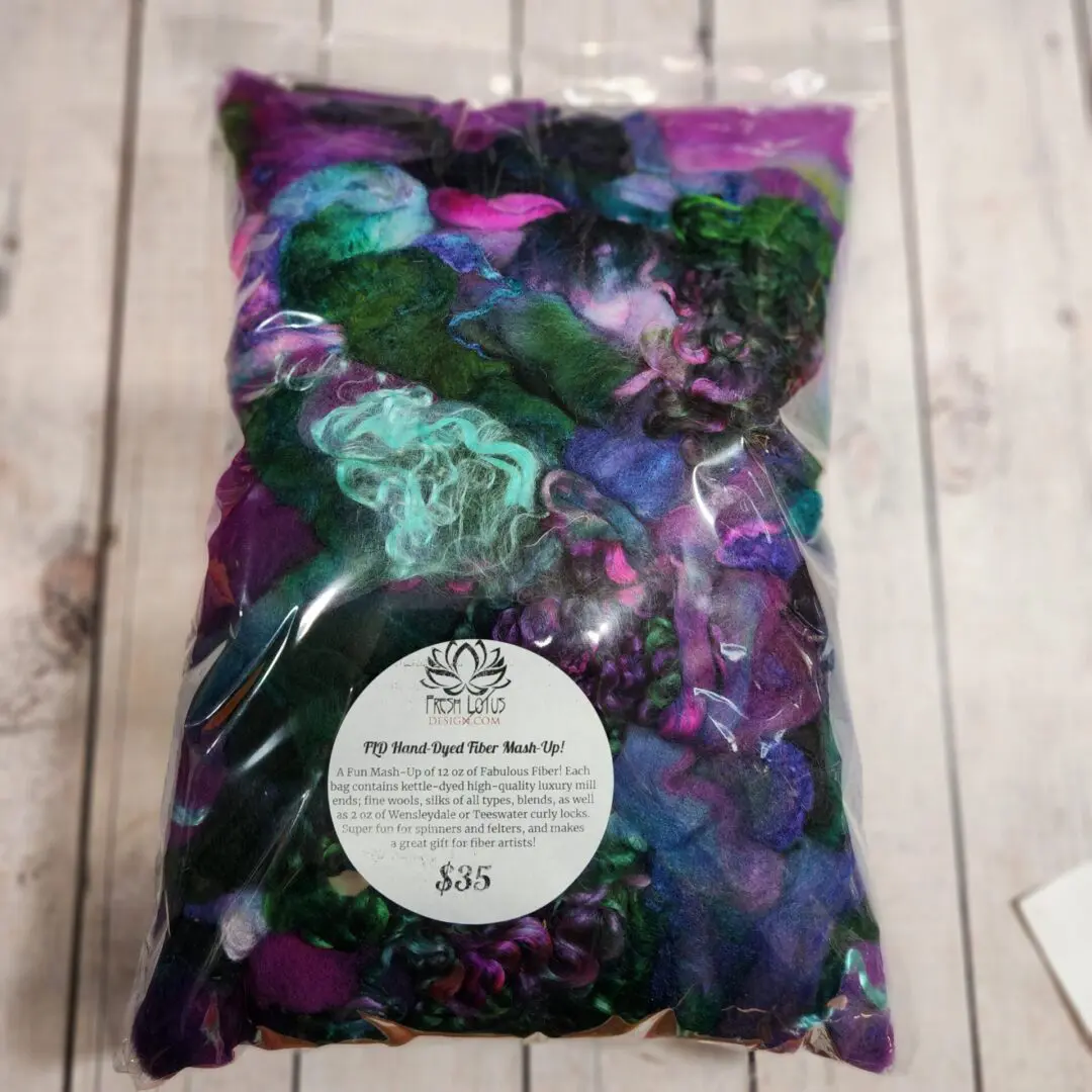 Bag of colorful hand-dyed fiber for felting.
