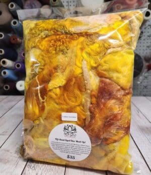 A bag of yellow dyed fabric on a table.