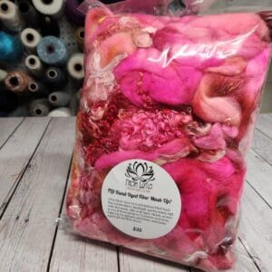 A bag of pink and white fibers on a table.