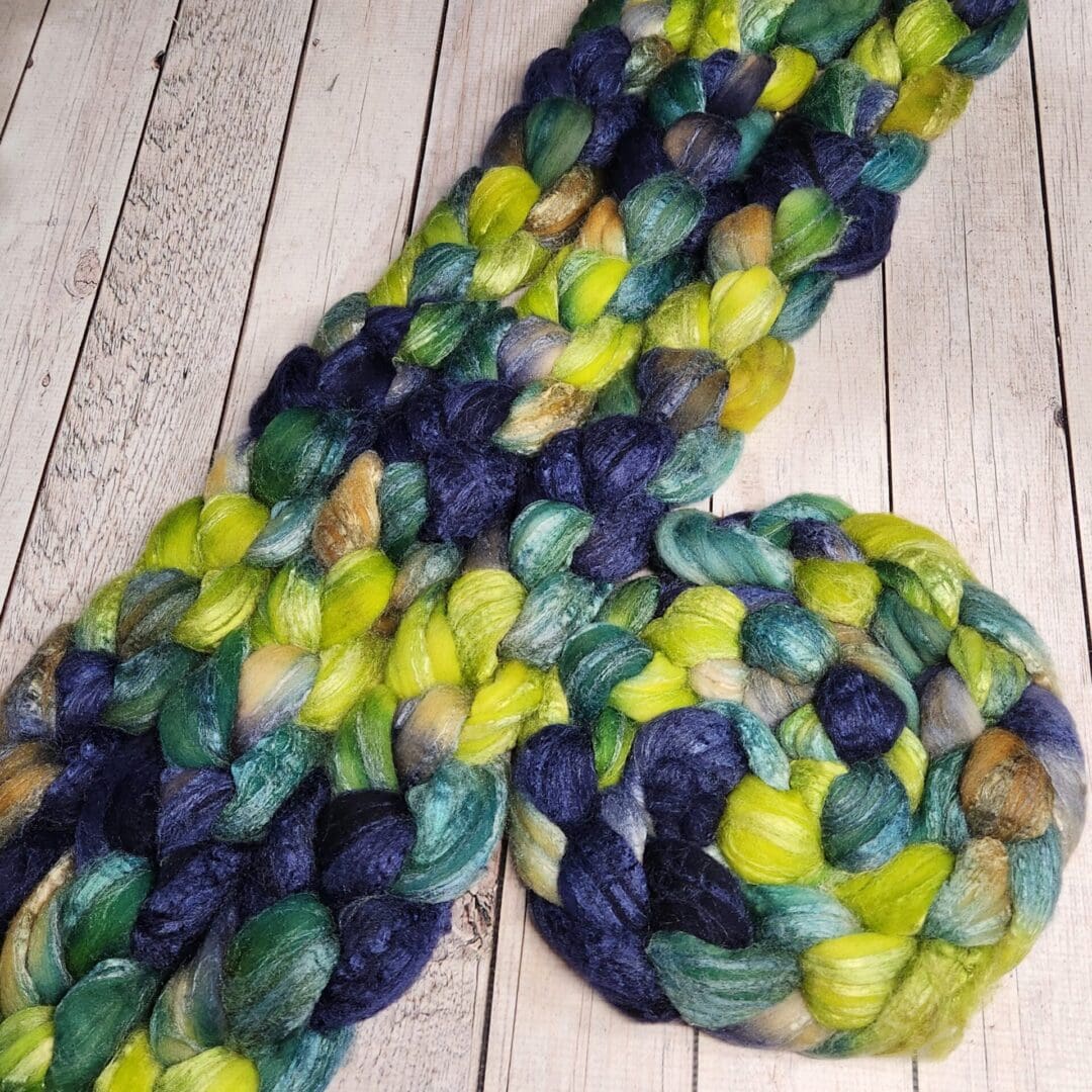 Braided yarn in blue, green, and yellow.