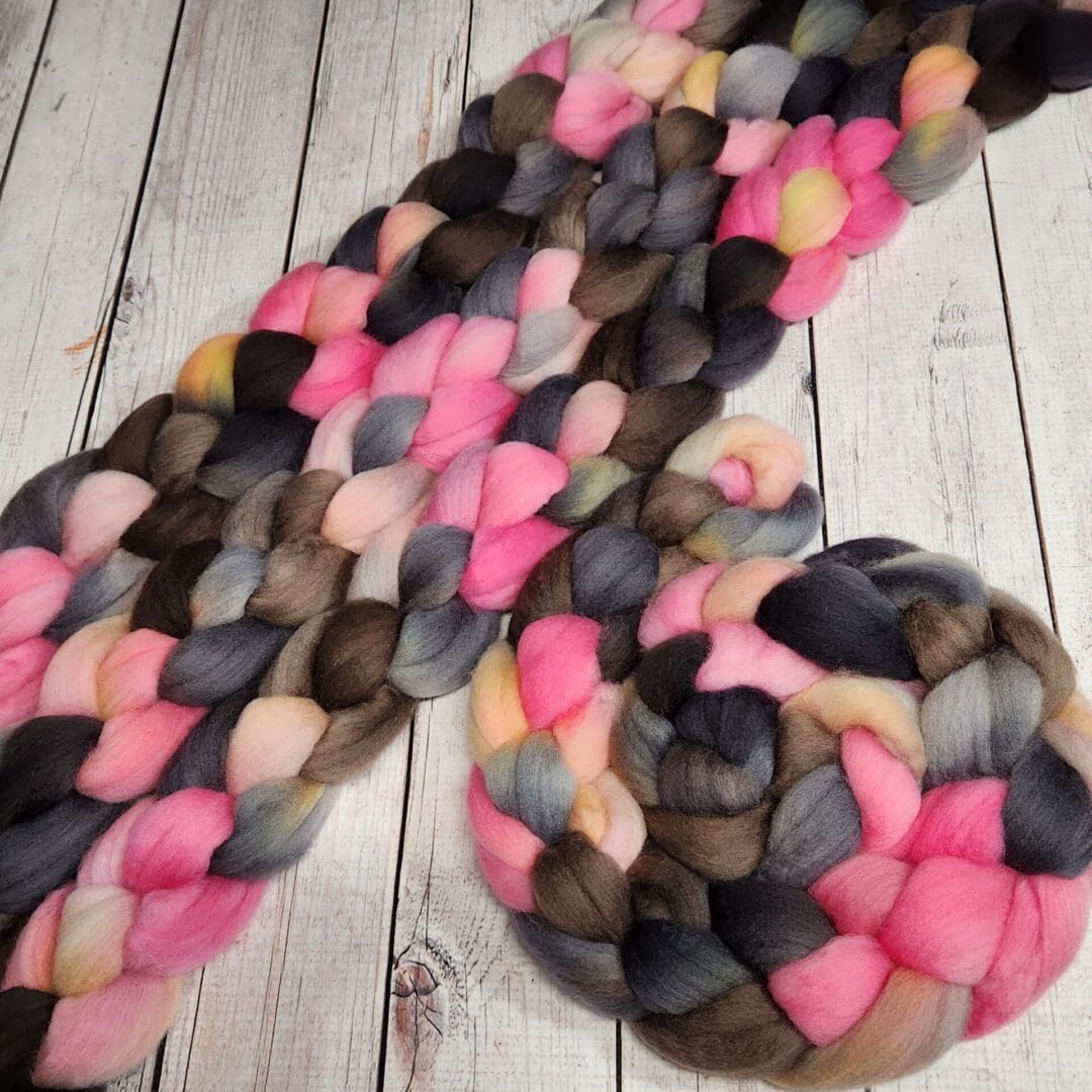 Braided yarn in pink, brown, and grey.