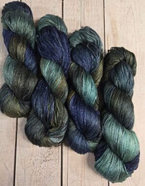 Four skeins of variegated blue-green yarn
