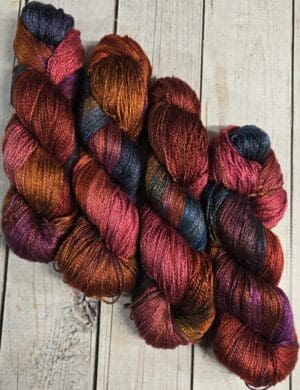 Variegated hand-dyed yarn skeins on wooden planks