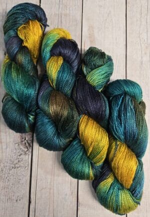 Variegated teal, green, and gold yarn skeins