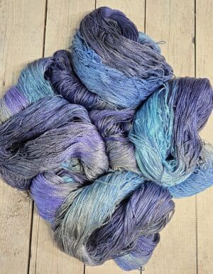 Close-up hand-dyed blue and purple yarn skeins