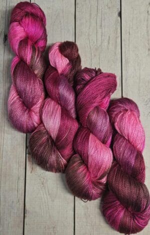 Pink and burgundy variegated yarn skeins