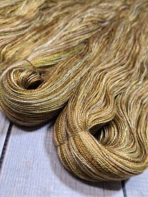 Golden variegated yarn skeins on wood